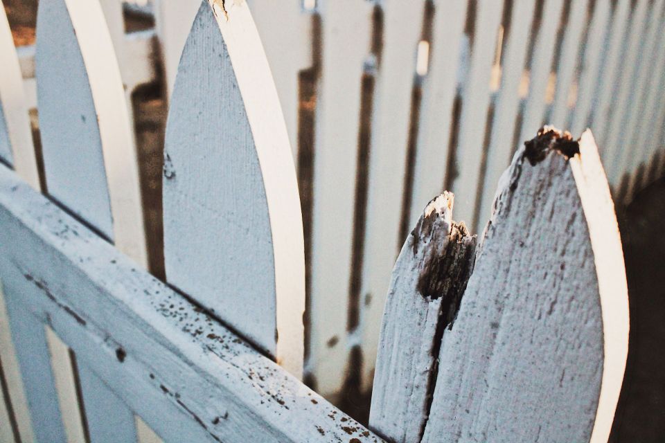 Weathered wooden fence in need of repair
