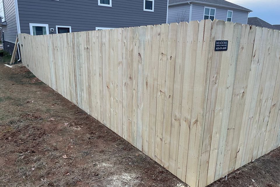 Wooden privacy fence installed around a family backyard