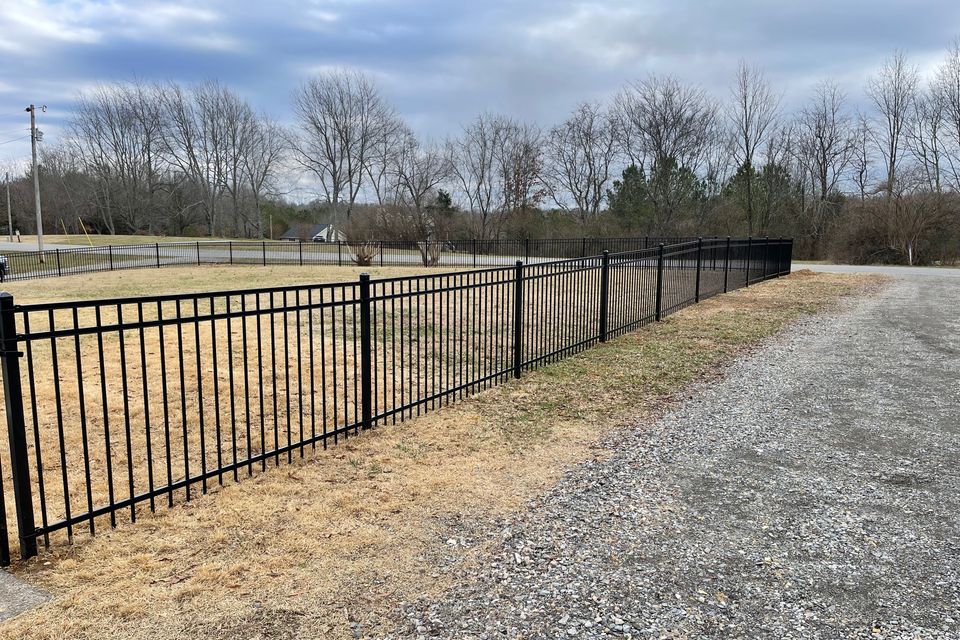 Black ornamental metal fence with decorative pickets