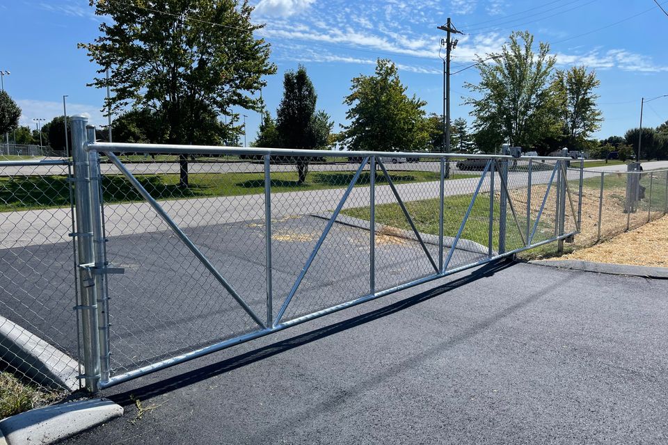 Galvanized chain link fence installed along a residential property line
