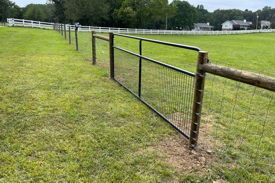 Woven wire livestock fence running along a Tennessee pasture